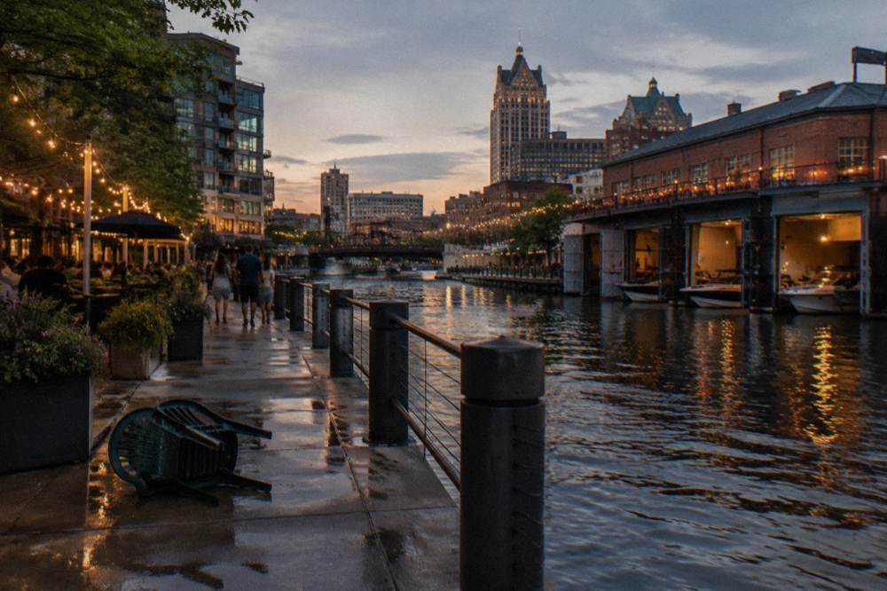 Riverfront patios and boathouses along the Milwaukee Riverwalk at dusk
