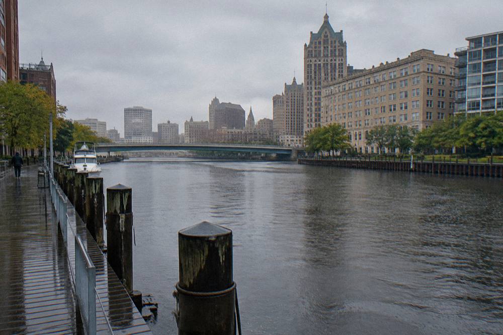 Overcast sky above the Milwaukee River with the downtown skyline behind light rain on the water