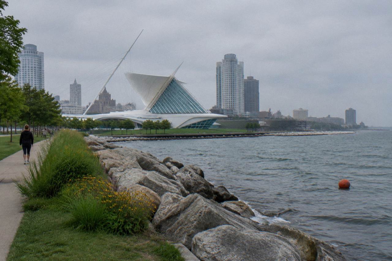 Calm harbor water along the Milwaukee lakefront with the downtown skyline in soft light