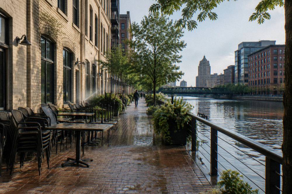The Milwaukee Riverwalk passing restaurants with the river on one side