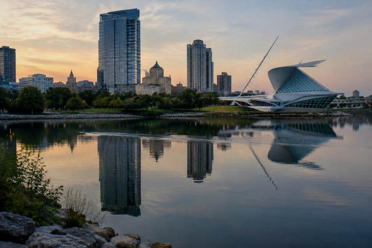 Downtown Milwaukee skyline reflected in the Milwaukee River on a calm summer evening