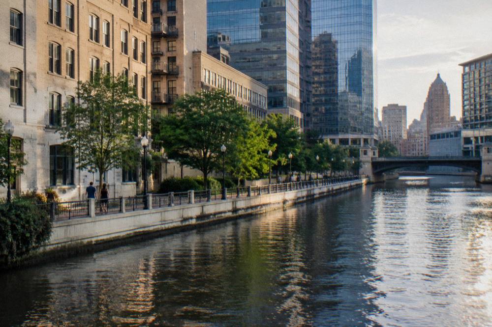 The Milwaukee Riverwalk along the river with buildings on both banks