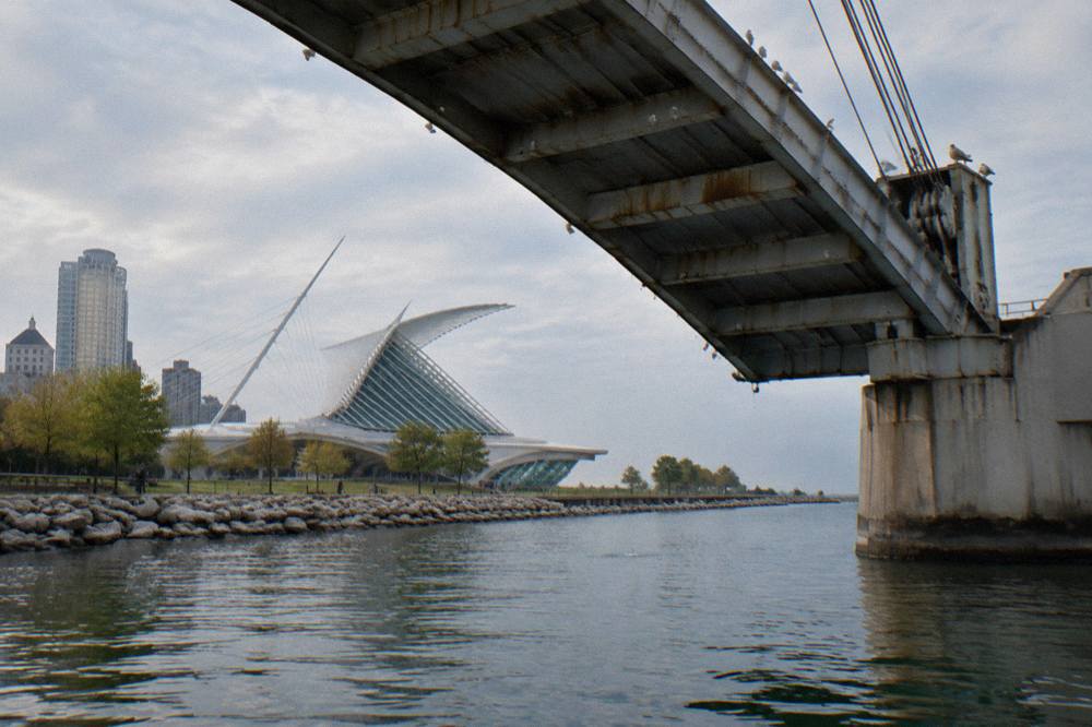 A bascule bridge over the Milwaukee River with its leaf raised, seen from the water