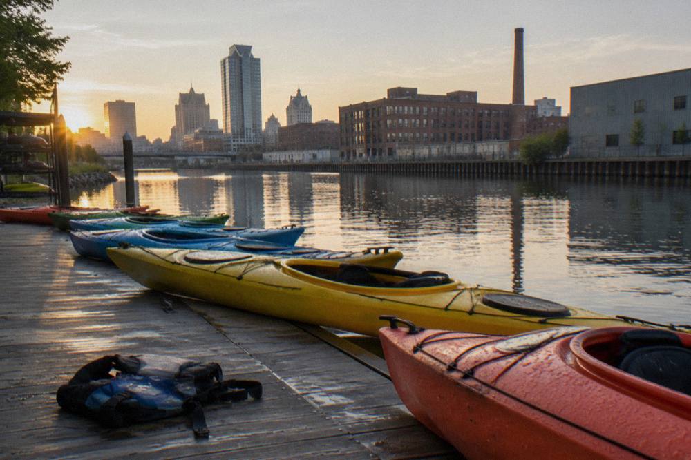Kayaks lined up on a dock along the Milwaukee River in the Harbor District