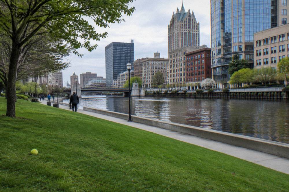Pere Marquette Park along the Milwaukee River with downtown buildings behind it