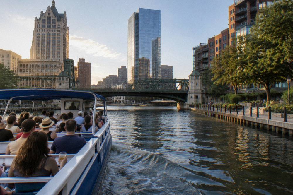 A tour boat passing under a downtown Milwaukee bascule bridge on the river