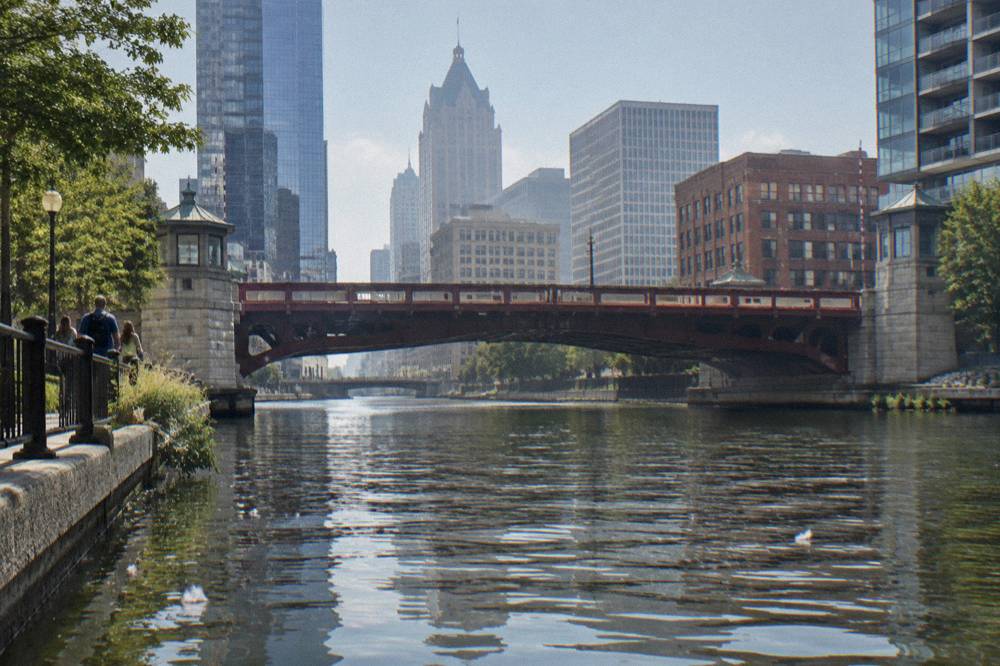 A drawbridge spanning the Milwaukee River with downtown buildings behind it