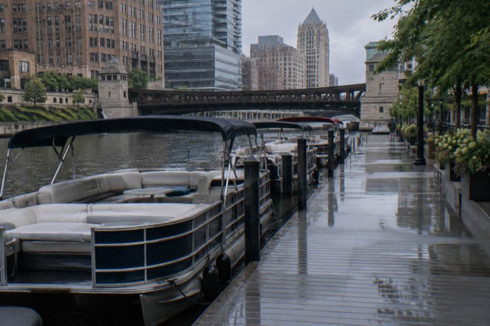 Pontoon boats moored on the Milwaukee River near the Riverwalk