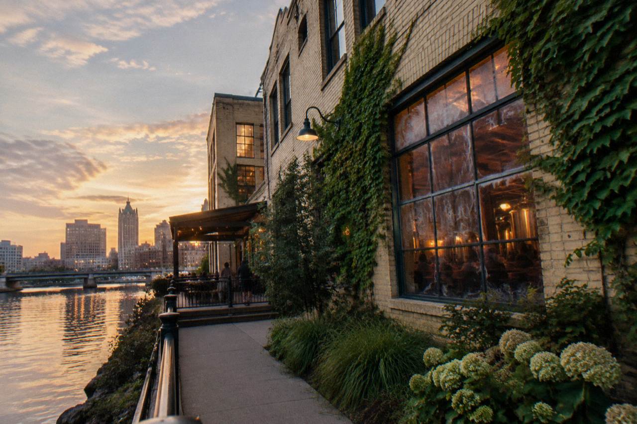 Brewery buildings along the Milwaukee River with the Riverwalk in the foreground