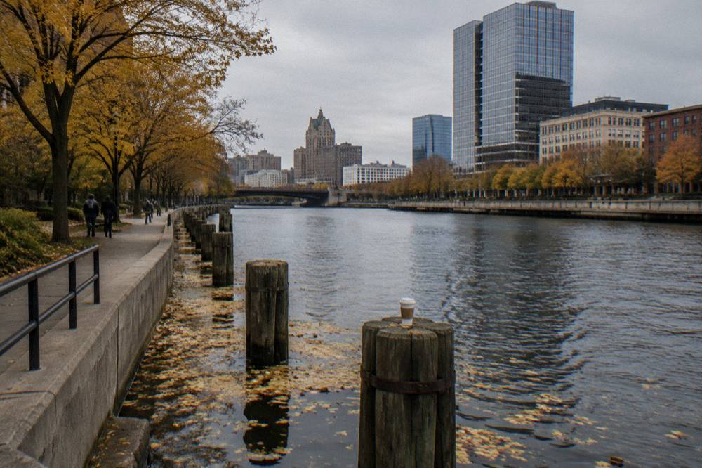 Autumn trees along the Milwaukee Riverwalk with the river in the foreground