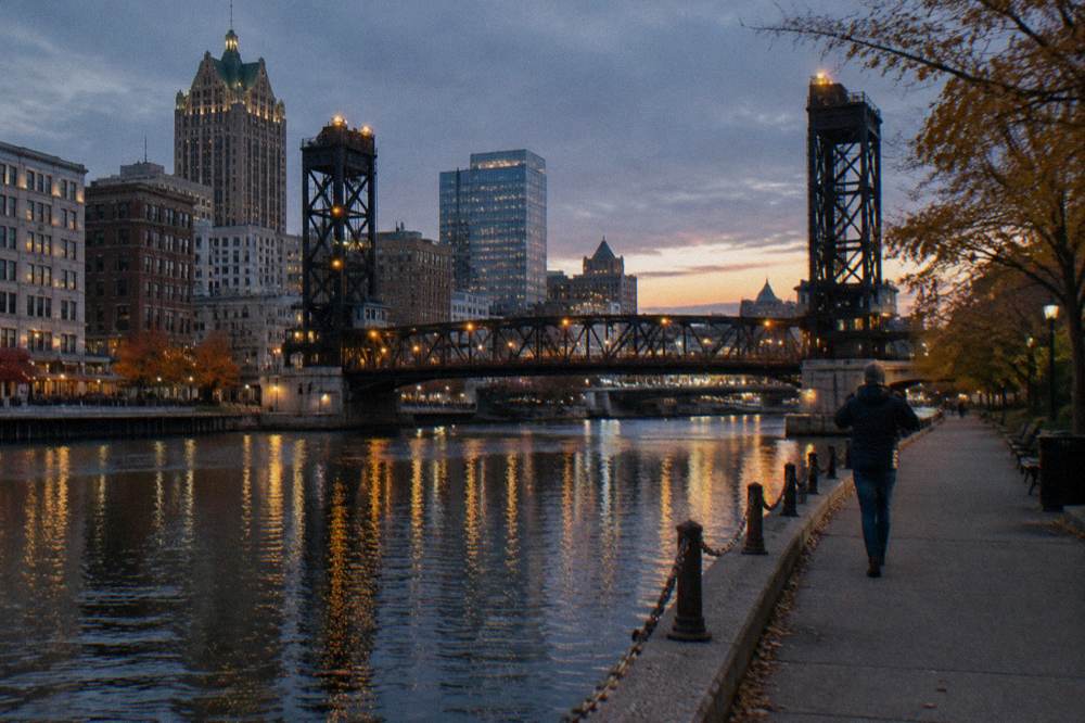 Milwaukee River at dusk with bridge lights reflecting on the water